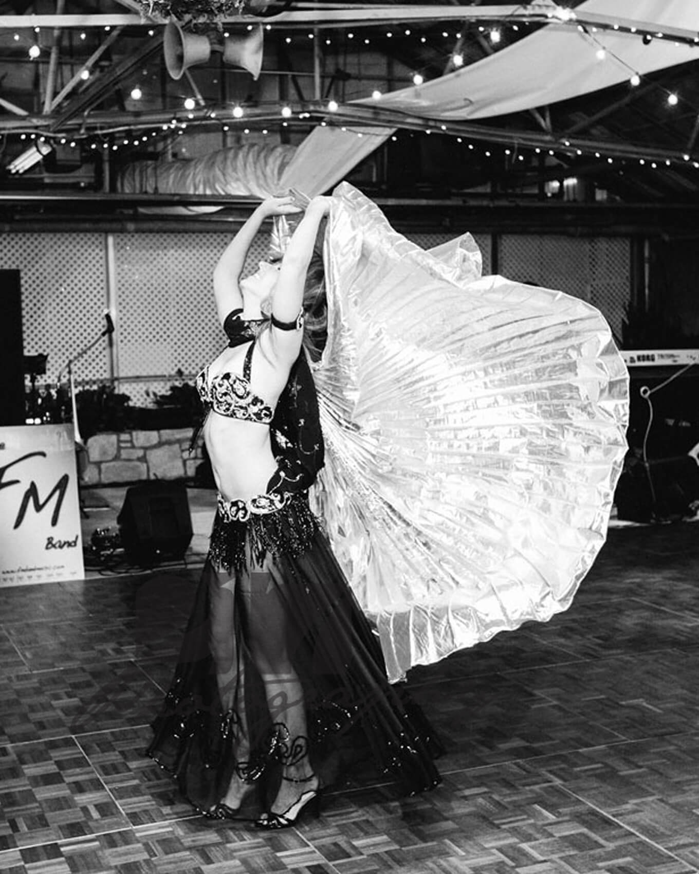 Donna performs using her belly dancing outfit with isis wings