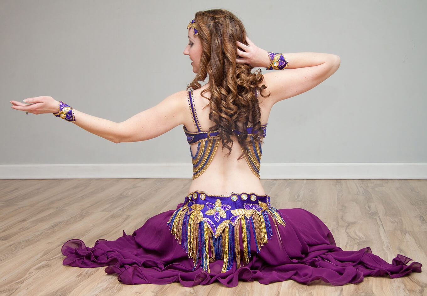 Donna showcasing one of her purple belly dance outfits