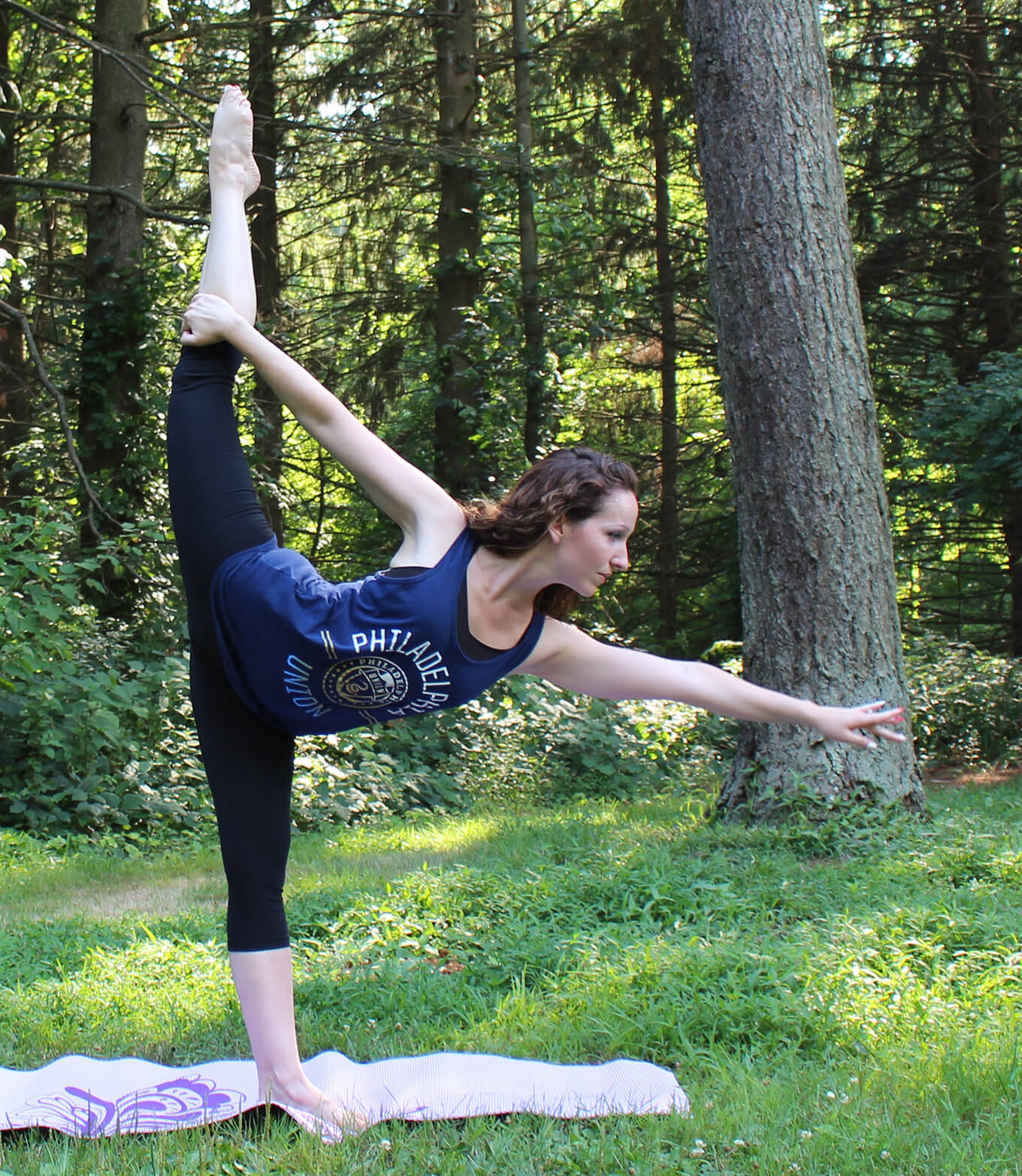 Donna demonstrating a standing split yoga pose